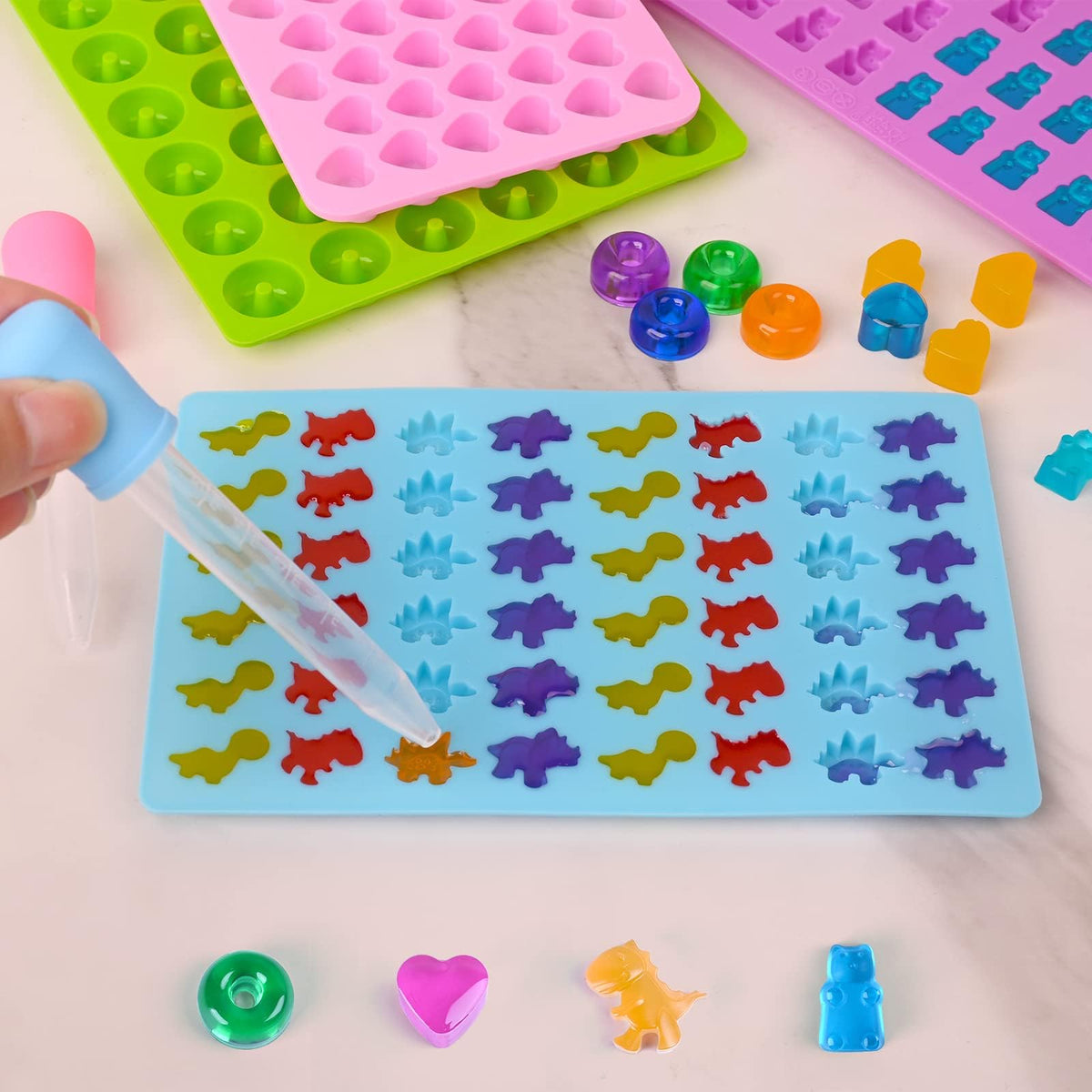 KASTWAVE Gummy Candy Molds Silicone with 2 Droppers Pack of 4 Mini Silicone Molds Including Dinosaur, Bear Shape, Hearts and Donut Gummie Chocolate Molds for Kids